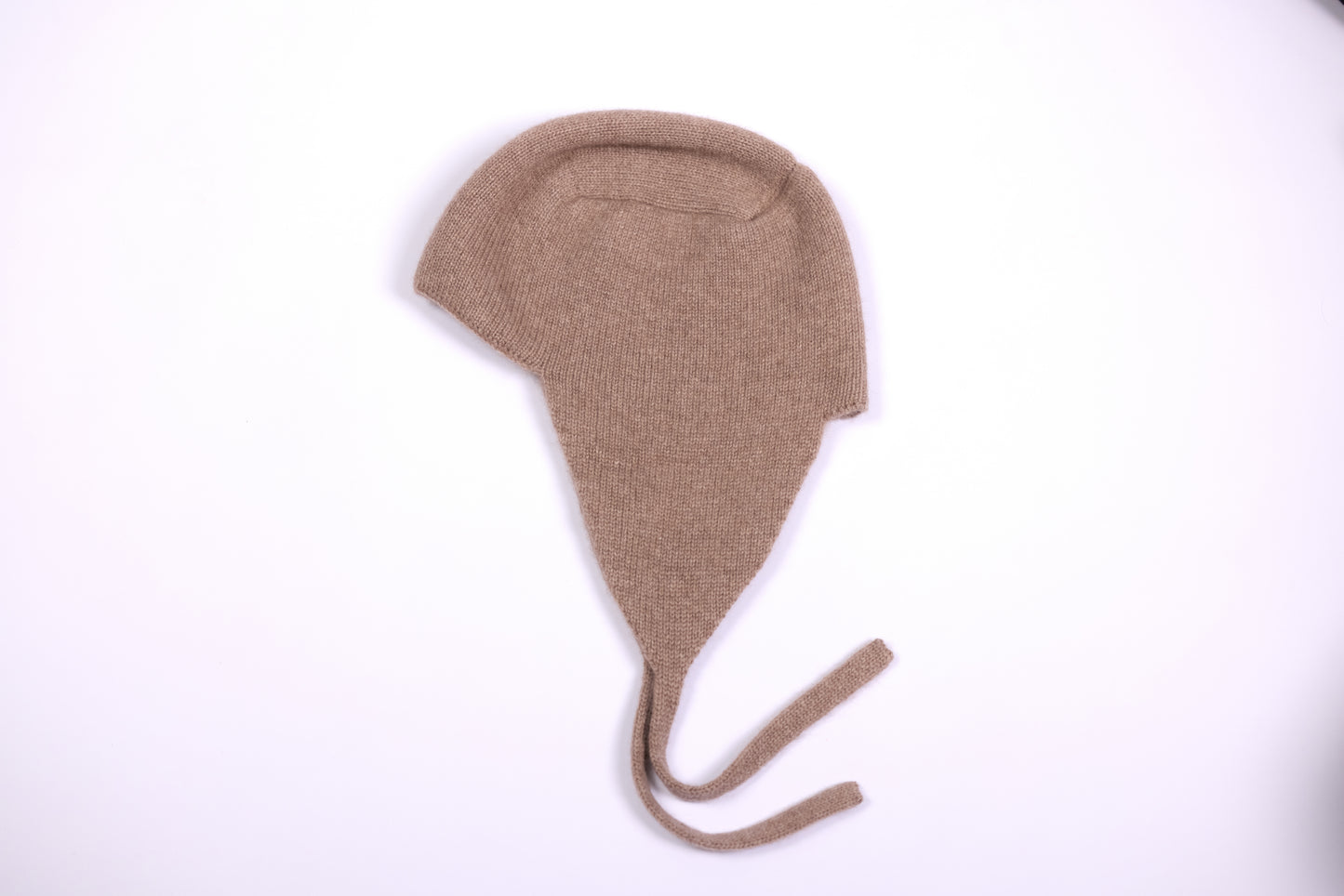 This design features a snug fit that covers the ears and ties under the chin for added warmth and security. It is inspired by traditional aviator-style headgear, blending functionality with modern fashion.