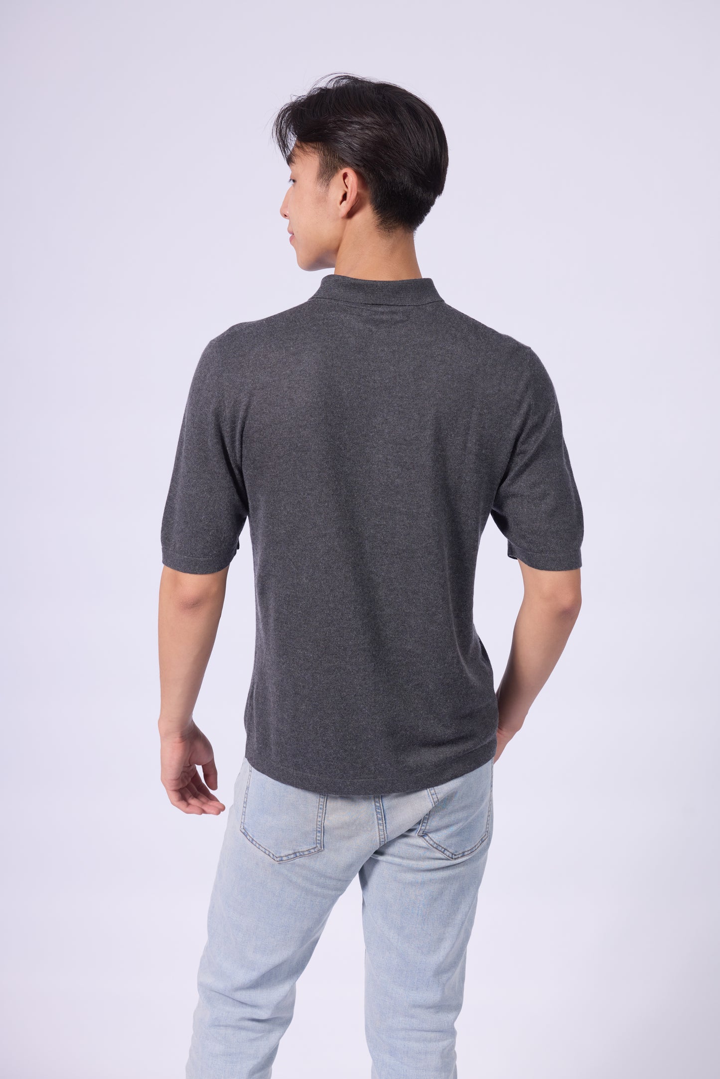 This is a men's polo shirt made from a silk-cashmere blend. The shirt is in a dark gray shade, offering a refined and minimalist look.