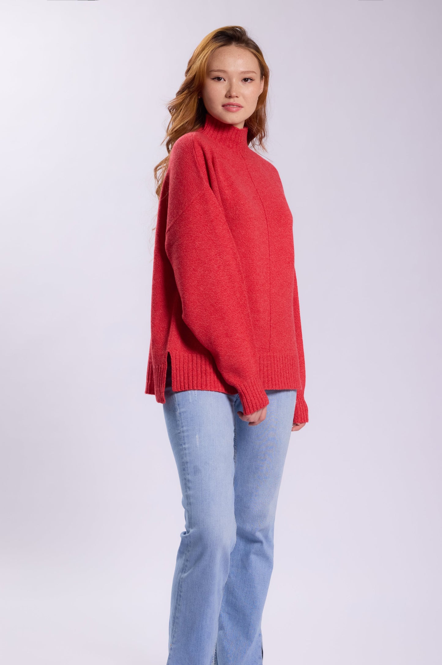 This cashmere sweater with a relaxed, oversized fit. It features a high mock neck, dropped shoulders, and long sleeves for a cozy appearance.